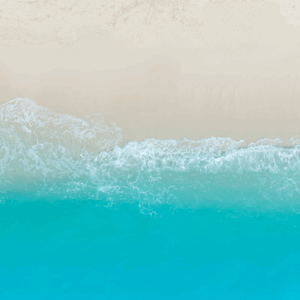 Beach shoreline with turquoise water waves.