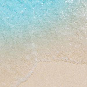 Gentle waves on sandy beach shore.